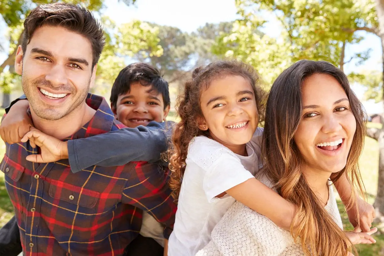 A family of four posing for the camera.