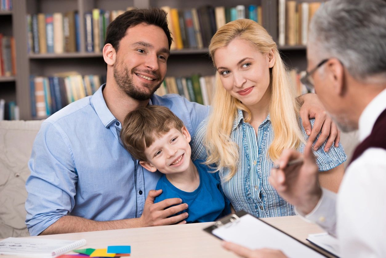 A family sitting at the table with a child